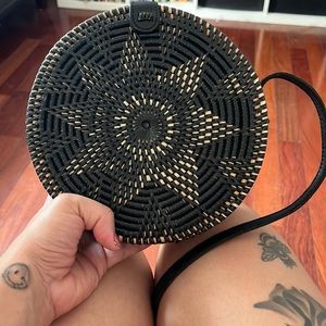 Round rattan black and beige purse with sun design
